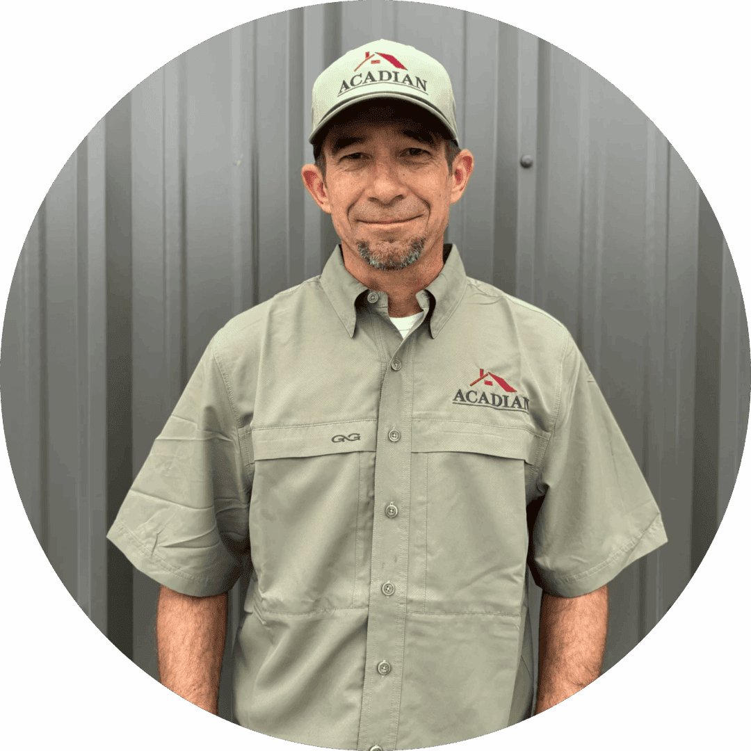 Man in uniform standing against metal wall.